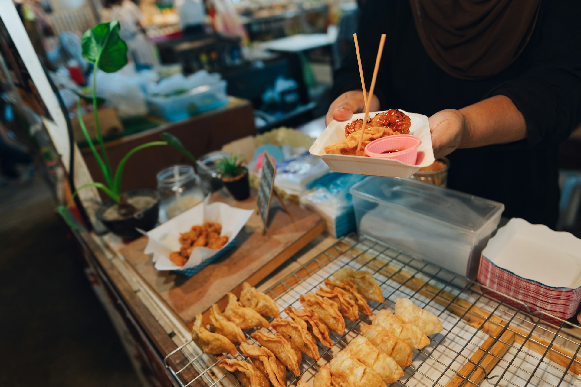 Fried snacks and dipping sauces served from a street food cart in Southeast Asia